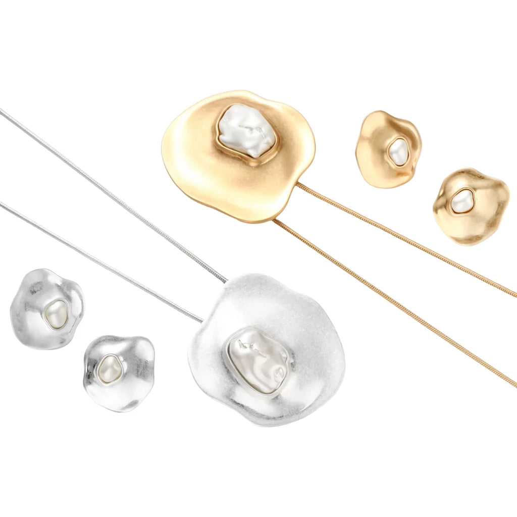 Organic-shaped eco-zinc alloy stud earrings with resin pearl centers and sterling silver posts on white background.