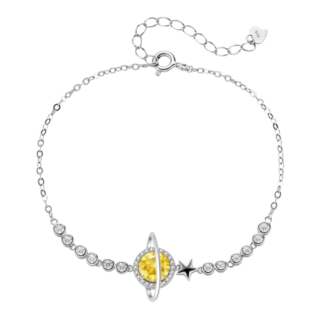 Sterling silver bracelet with yellow moissanite centerpiece in oval setting, crystal chain, and star charm on white background.
