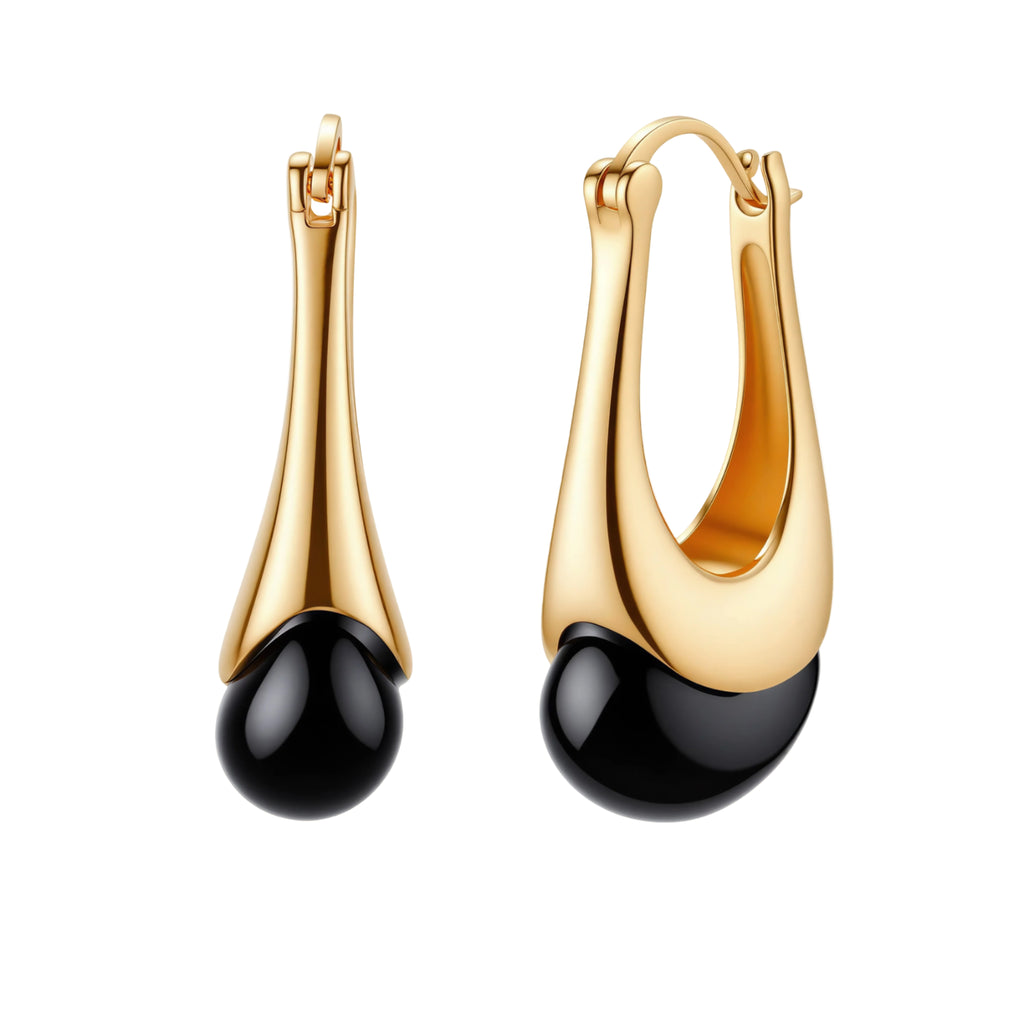 Gold-plated drop earrings featuring black agate stones with hoop closure on white background, showing elegant teardrop design.
