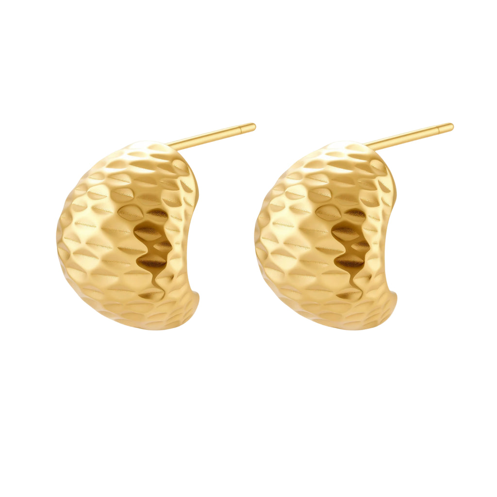 Pair of textured gold-plated sterling silver huggie earrings with dimpled surface finish on cream background.