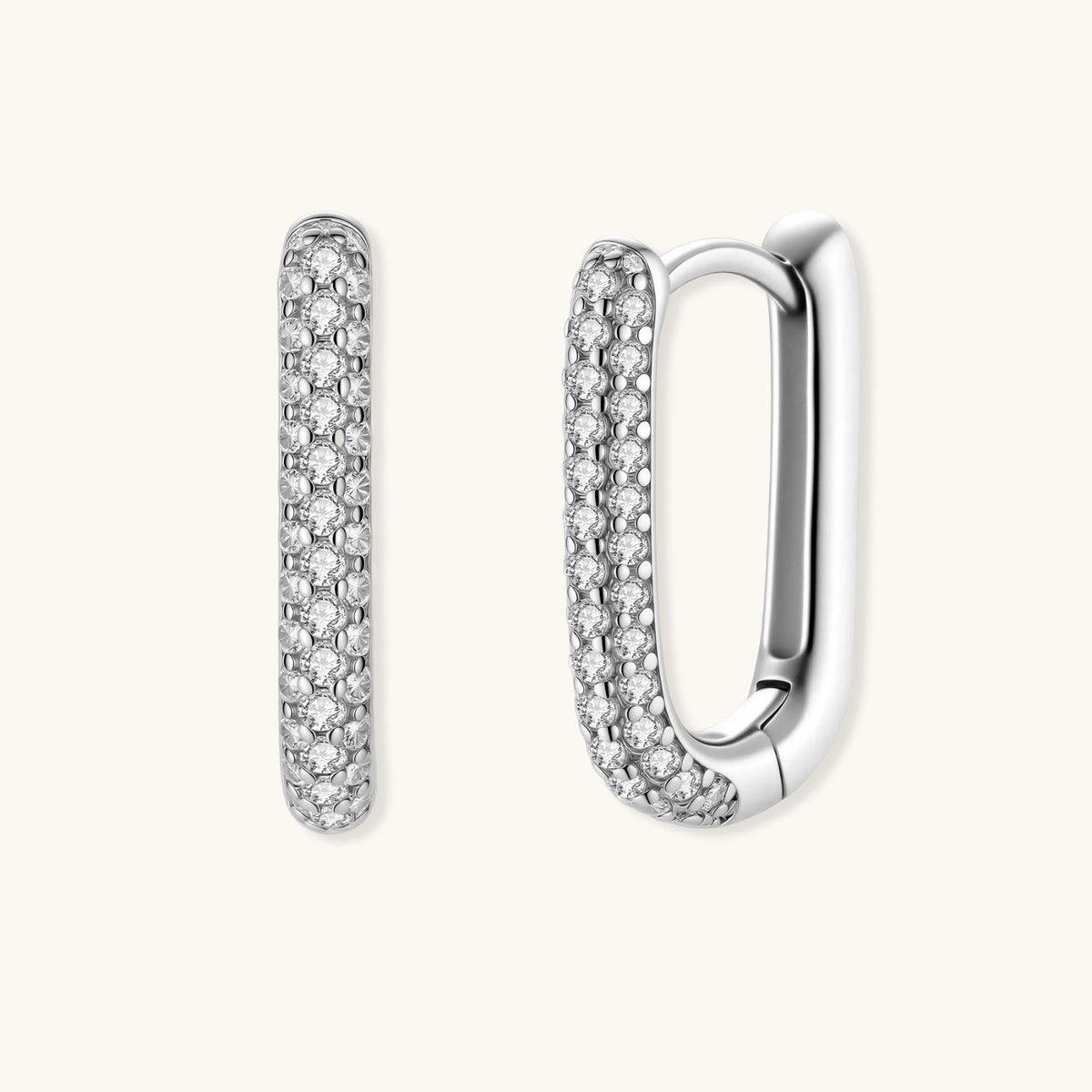 Close-up of small sterling silver huggie hoops completely covered in sparkling clear crystals with hinged closure