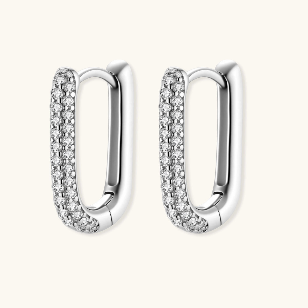 Close-up of small sterling silver huggie hoops completely covered in sparkling clear crystals with hinged closure