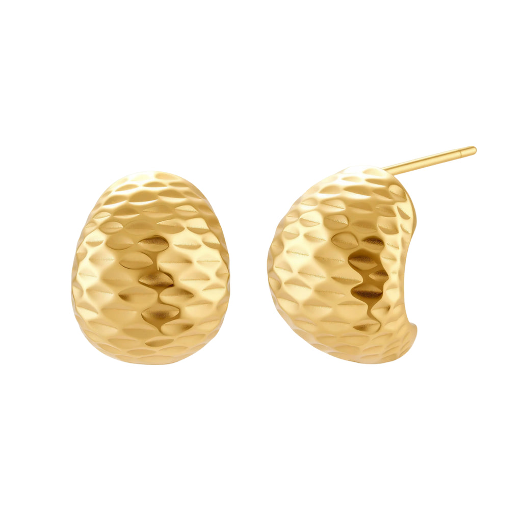 Pair of textured gold-plated sterling silver huggie earrings with dimpled surface finish on cream background.