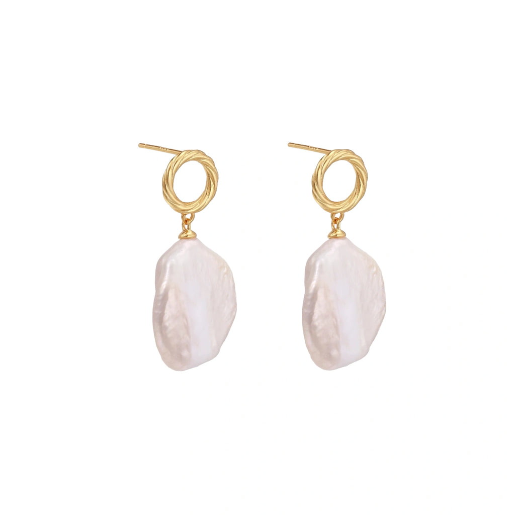 18K gold vermeil twisted circle studs with organic white baroque pearl drops on cream background