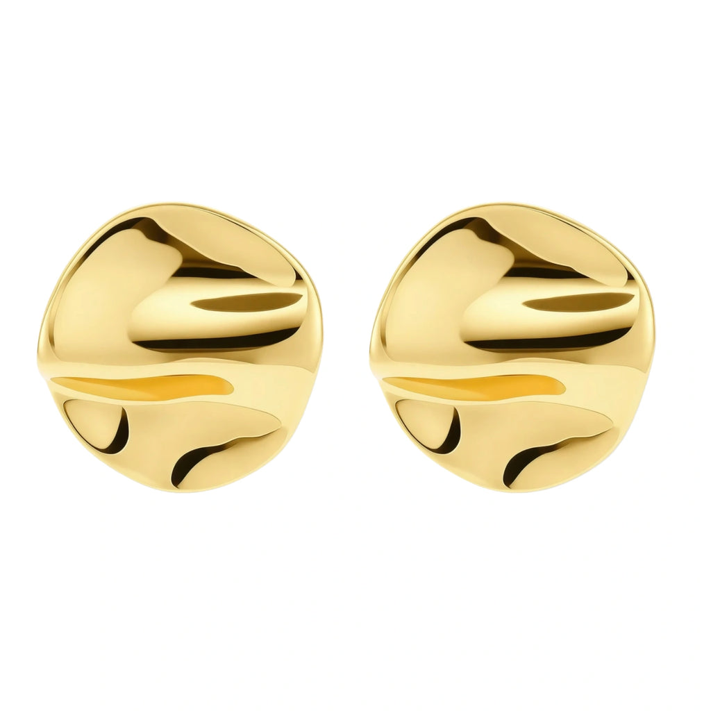 Close-up of organic gold-plated sterling silver stud earrings with flowing sculptural design and curved cut-outs