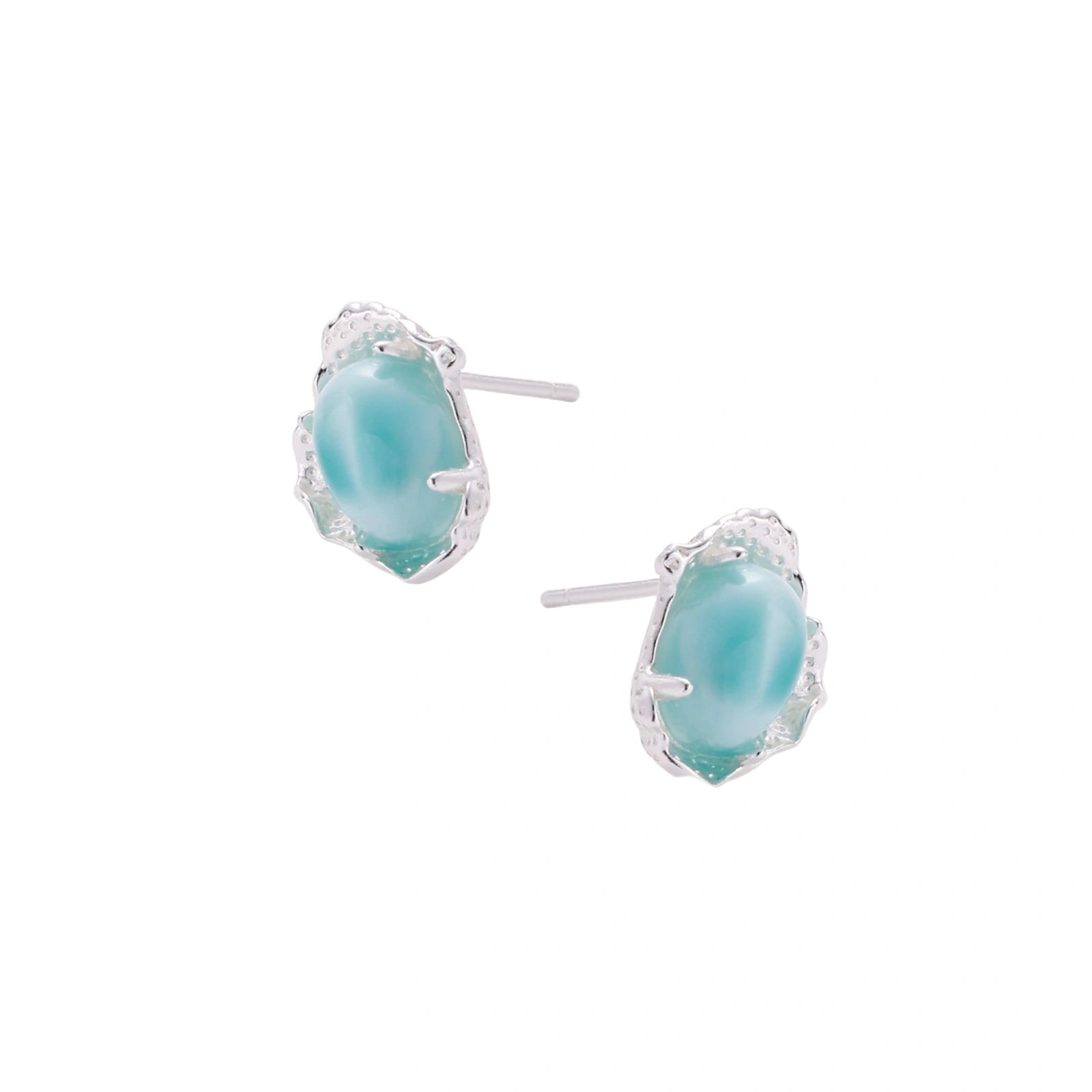 Oval larimar gemstone studs with ornate silver settings showing natural turquoise marbling on cream background