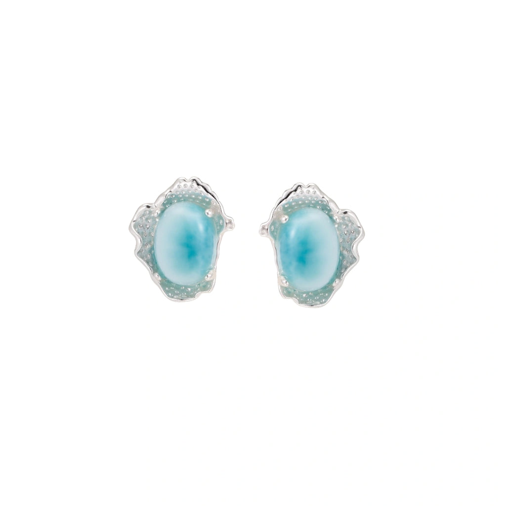 Oval larimar gemstone studs with ornate silver settings showing natural turquoise marbling on cream background