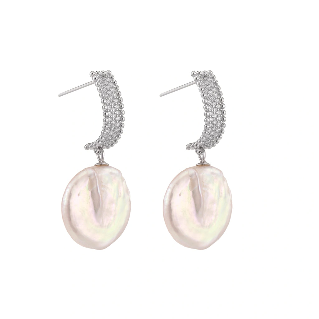 Rhodium-plated silver curved stud with pave stones and baroque pearl drop on white background
