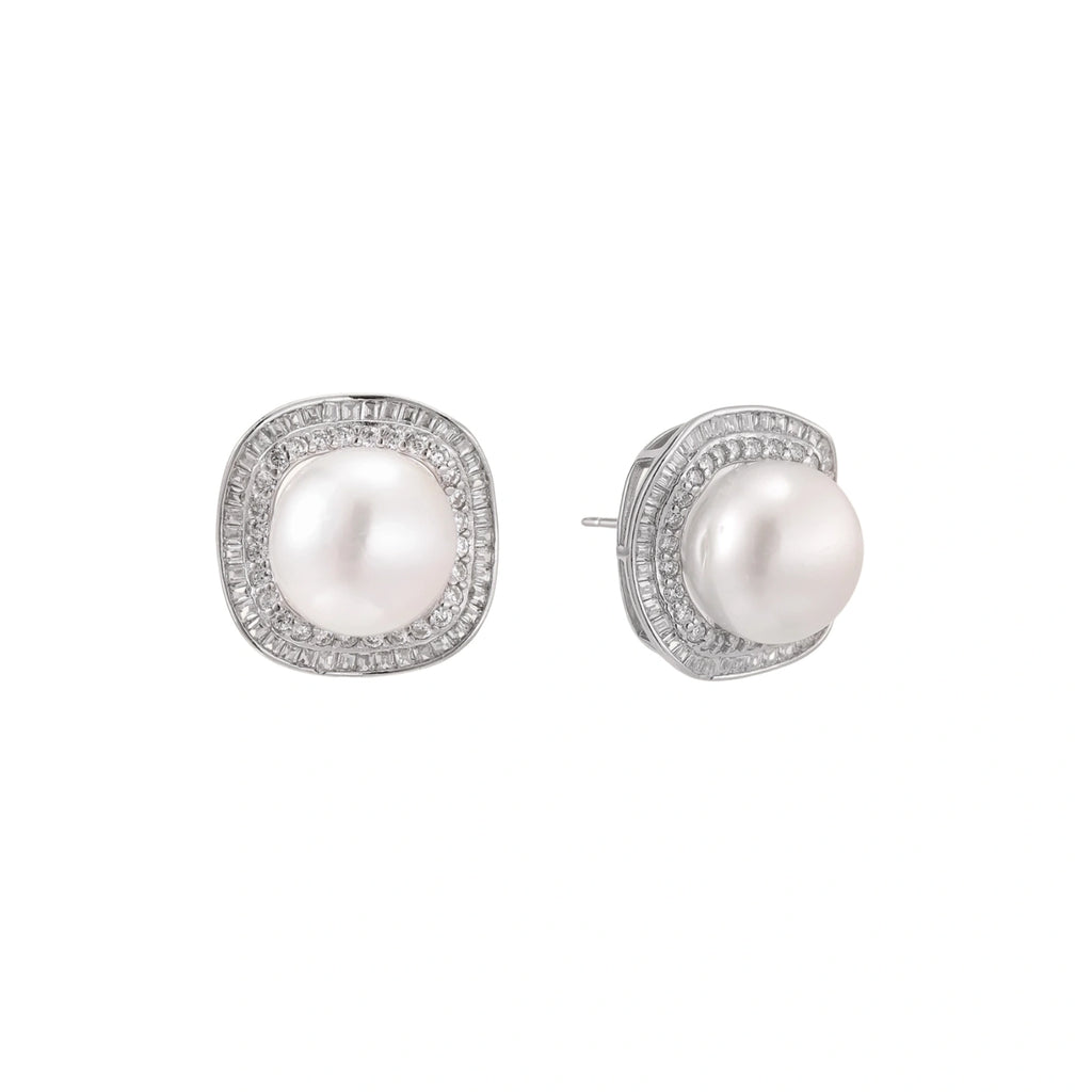 Rhodium-plated sterling silver stud earrings with round freshwater pearls surrounded by geometric crystal halos on cream background.