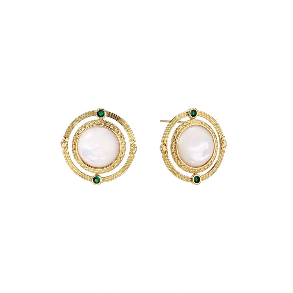 Circular gold stud earrings with iridescent mother-of-pearl center and green zirconia accents on cream background.