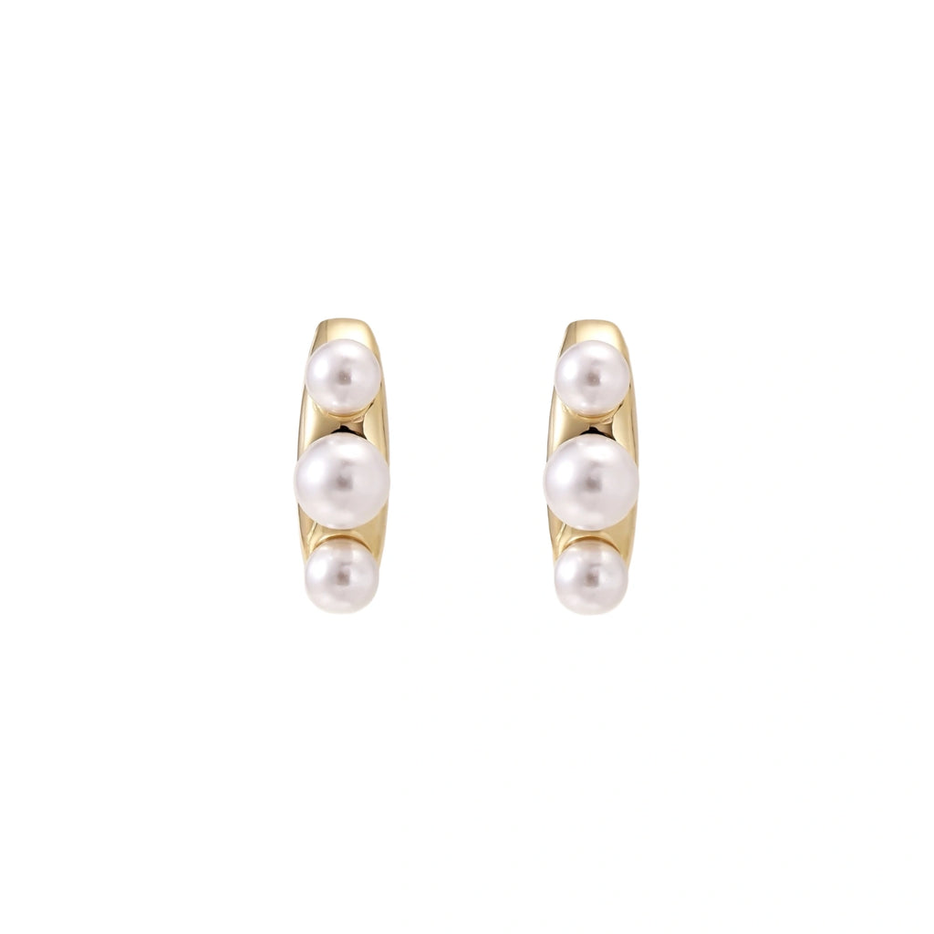 14K gold-plated curved stud earrings with three white freshwater pearls aligned vertically on cream background