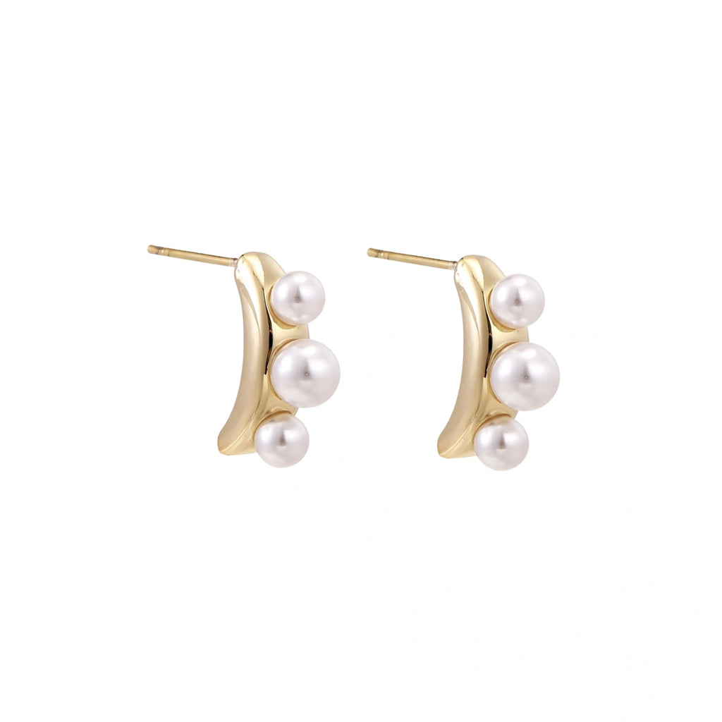 14K gold-plated curved stud earrings with three white freshwater pearls aligned vertically on cream background
