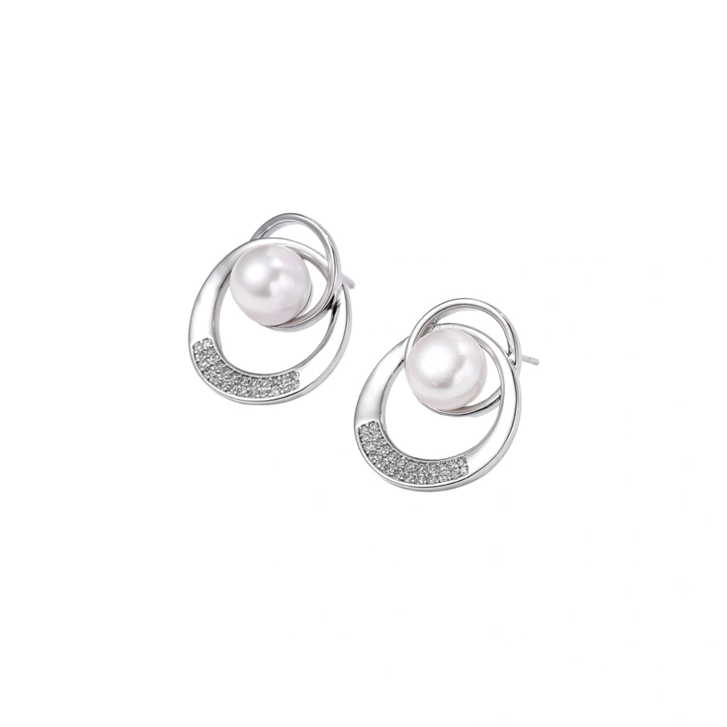 White gold-plated brass earrings with circular design, freshwater pearl center, and diamond accents