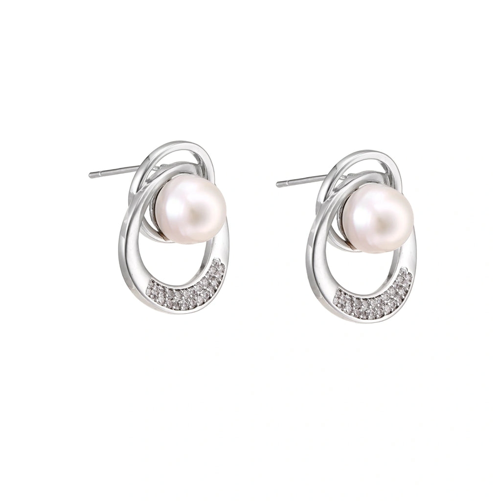 White gold-plated brass earrings with circular design, freshwater pearl center, and diamond accents
