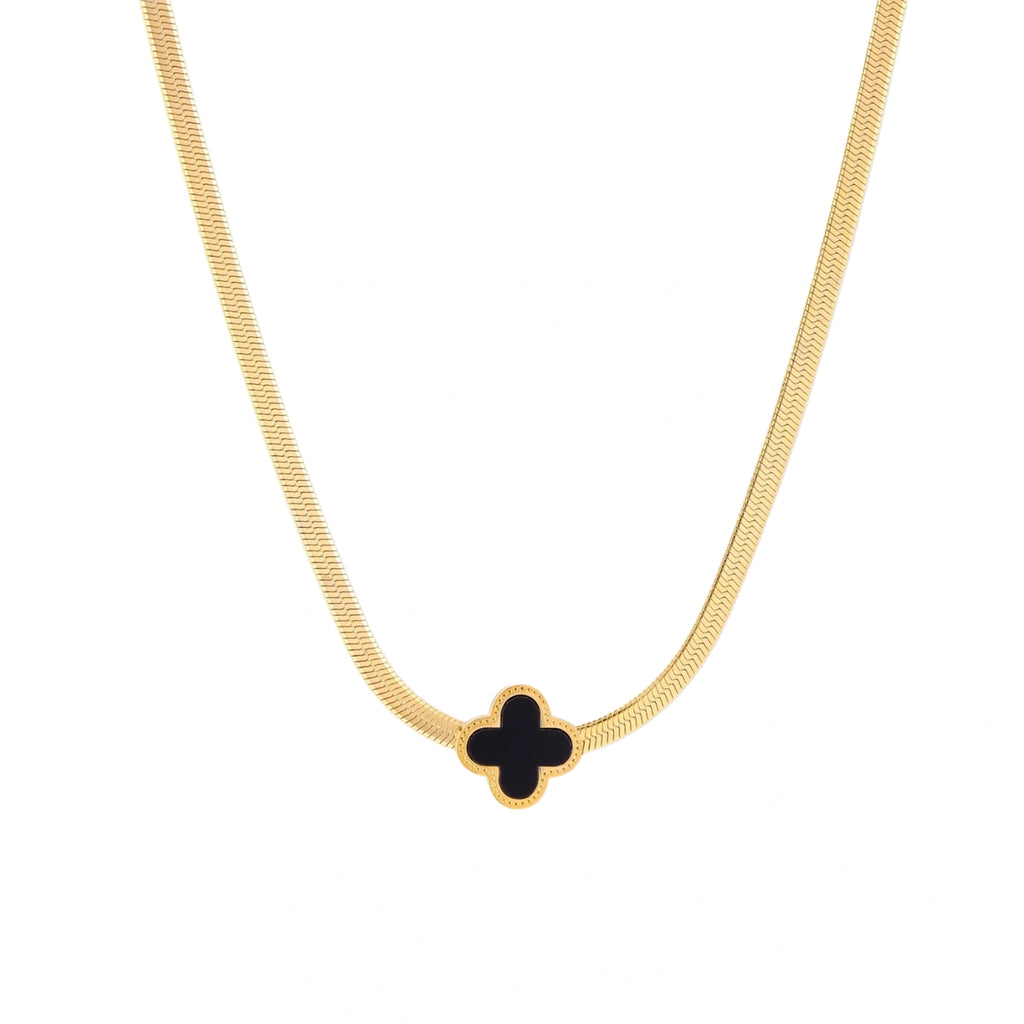 Dainty 18K gold-plated herringbone chain necklace with black enamel quatrefoil clover pendant on white background