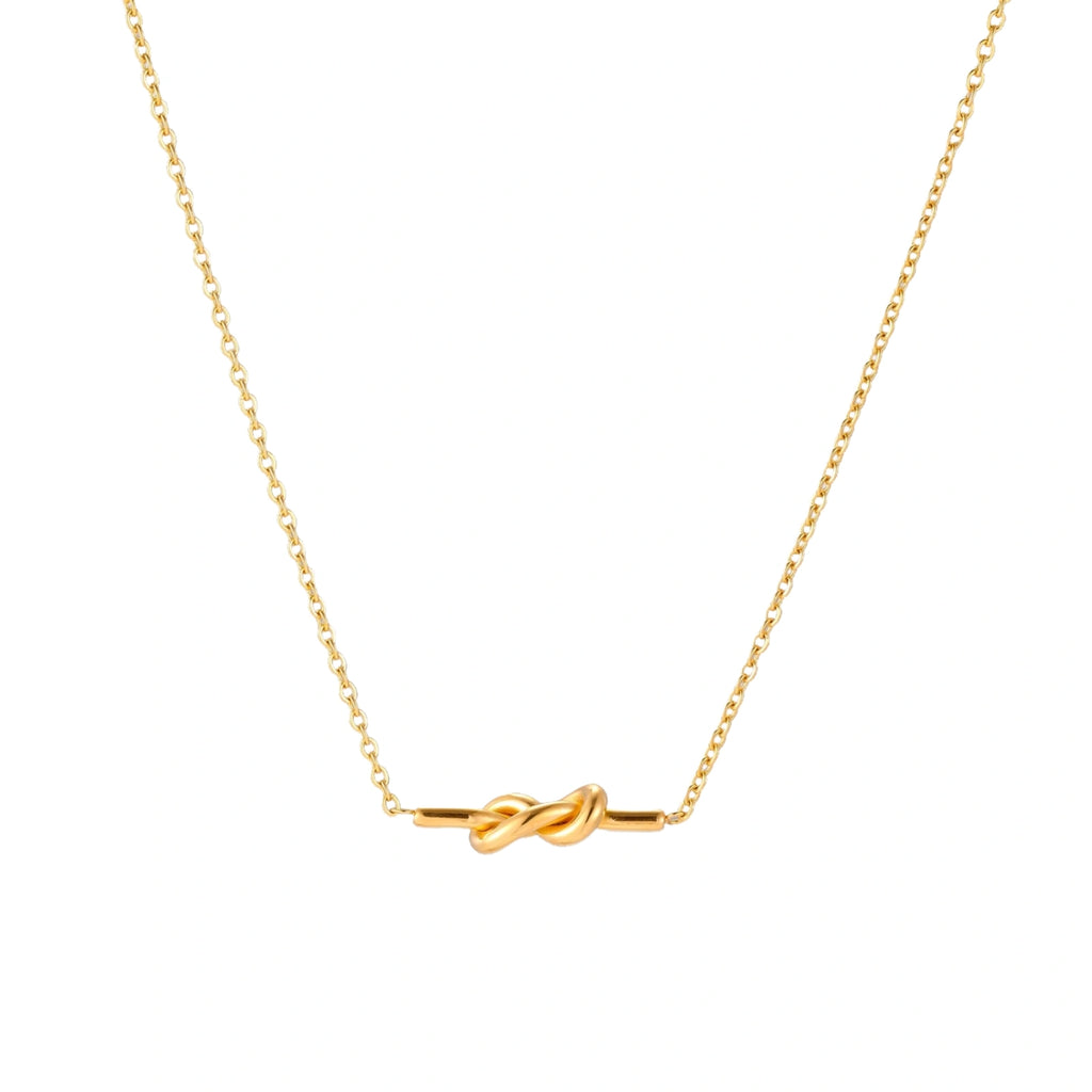 Dainty 18K gold plated necklace with infinity knot pendant on delicate chain against white background