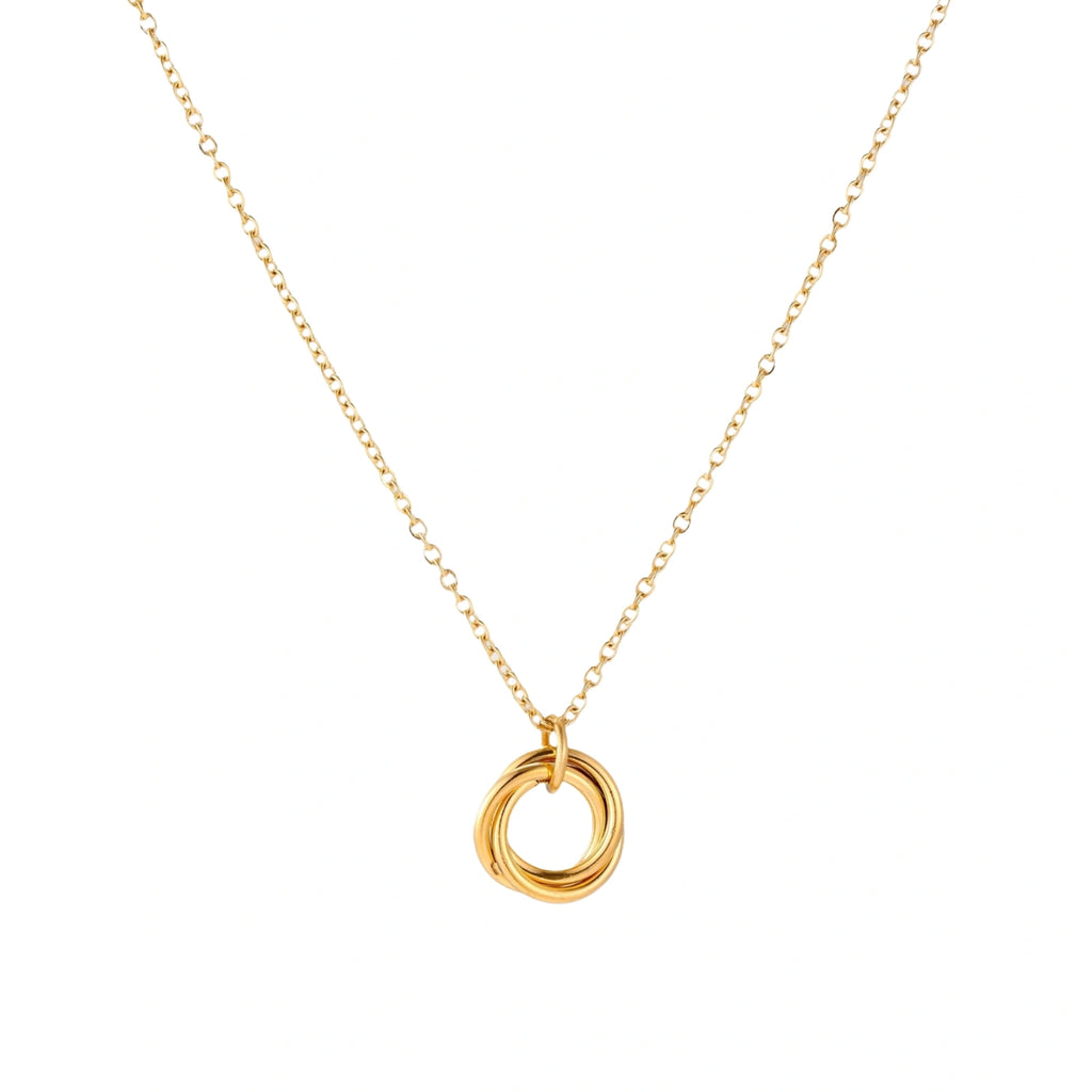 Delicate gold-plated necklace with three interlocking circle rings forming a minimalist knot pendant on cream background