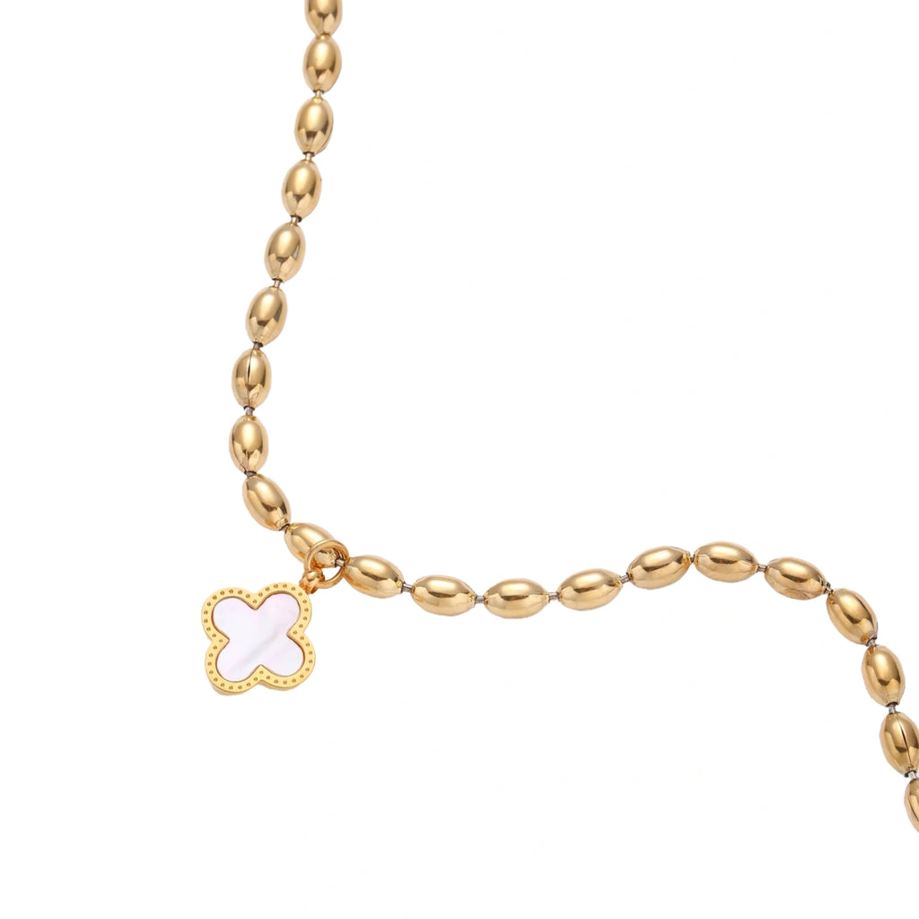 18K gold-plated oval bead chain bracelet with quatrefoil clover charm featuring mother of pearl inlay on cream background