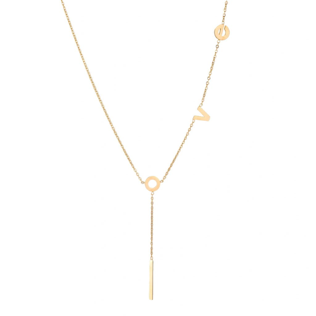 Gold Y-shaped necklace with L-O-V-E letter charms and vertical bar pendant on delicate chain against cream background