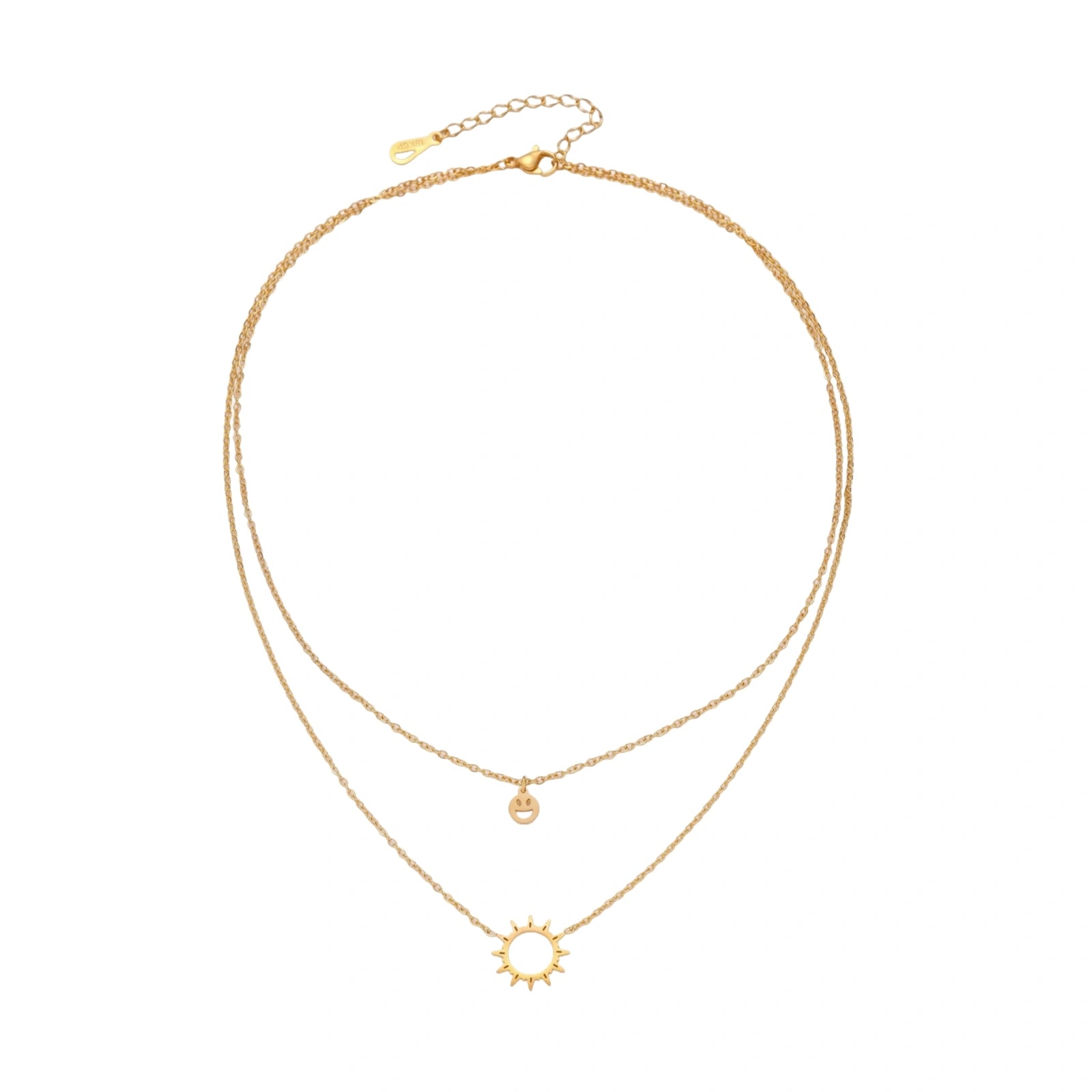 Gold layered necklace set with sunburst and smiley face pendants on delicate chains against white background.