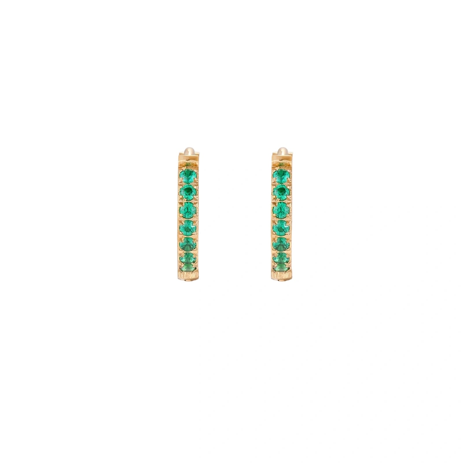 Pair of small gold huggie hoop earrings with bright green cubic zirconia stones on cream background