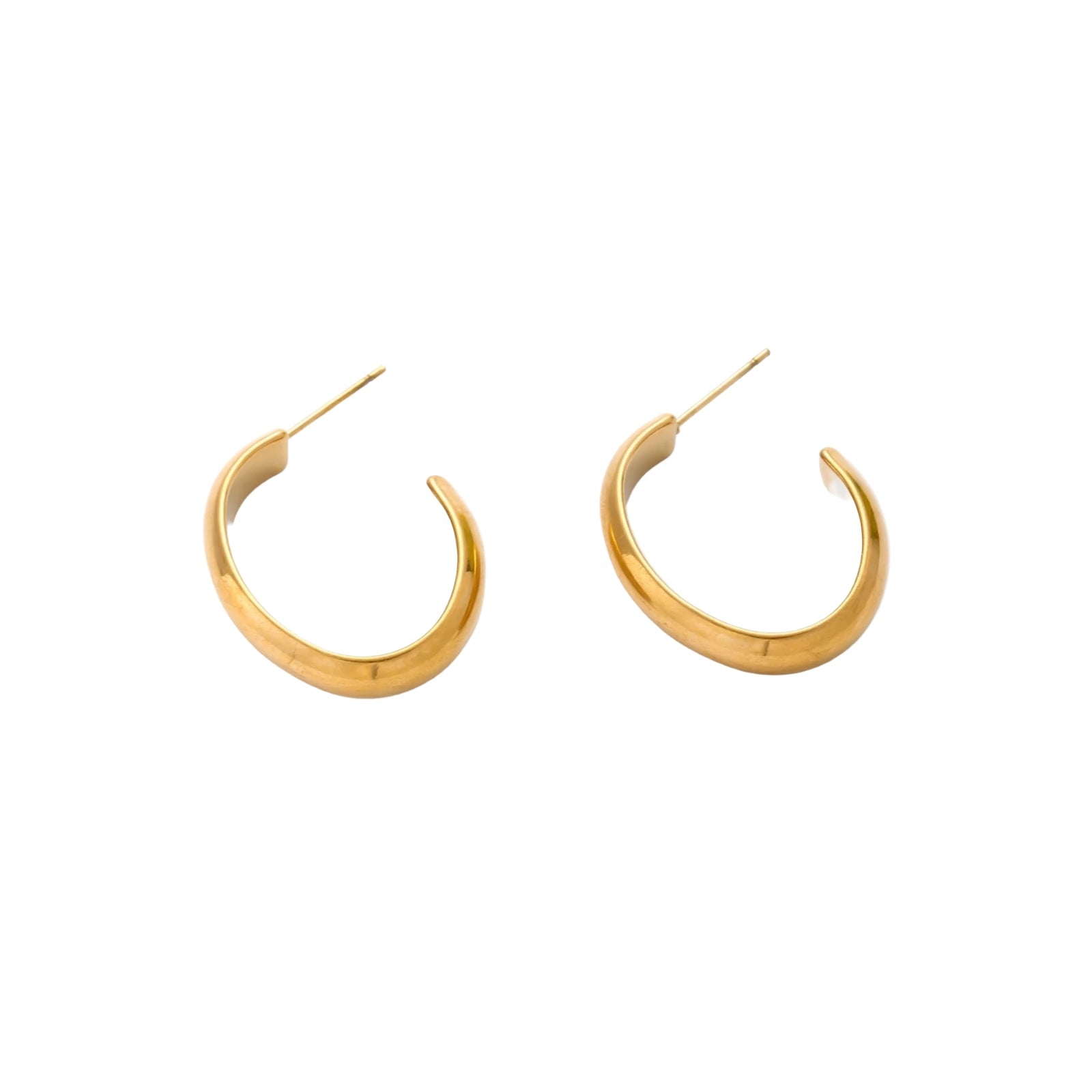 Chunky tubular hoop earrings in warm 14K gold-plated finish with smooth polished surface on cream background.