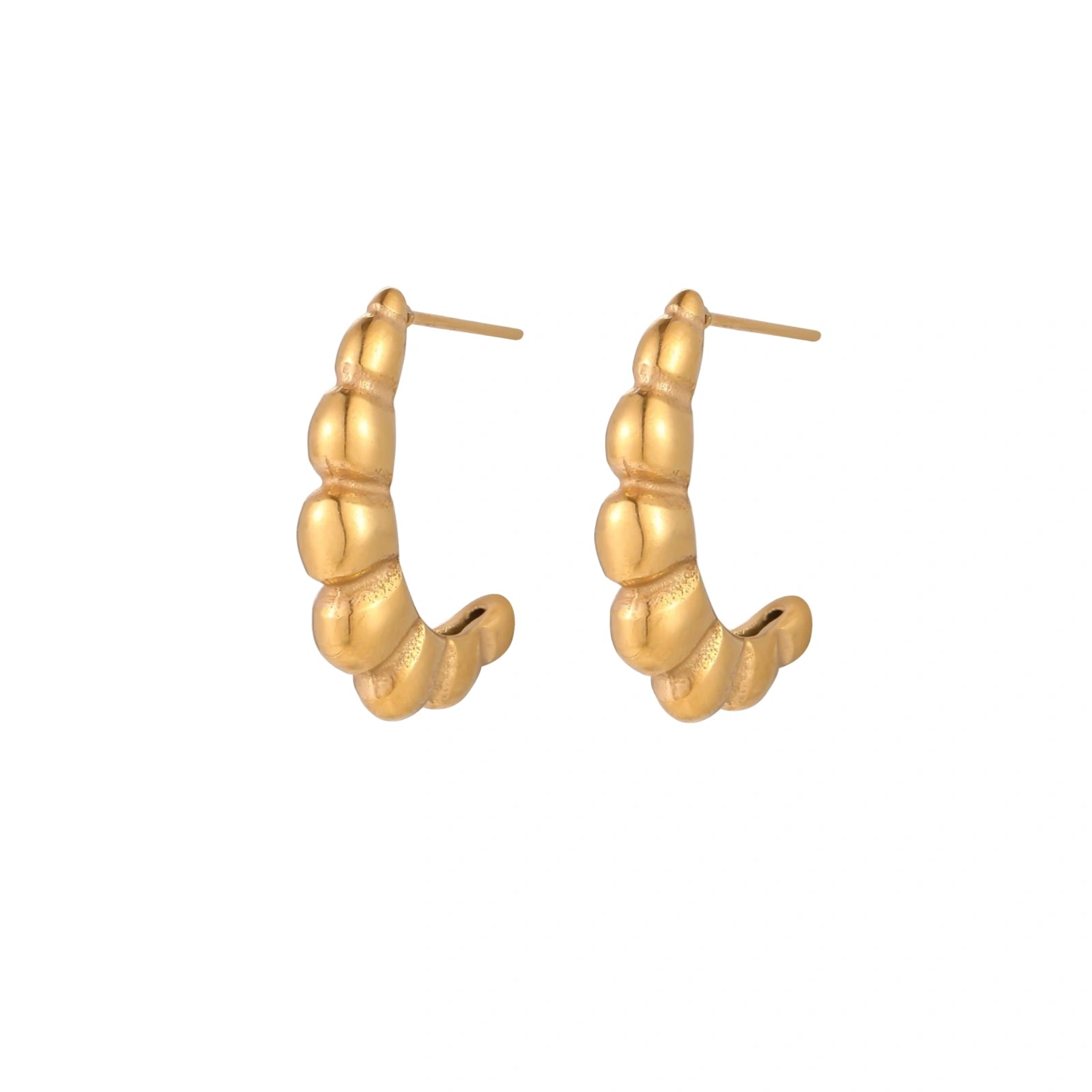 Gold-plated chunky hoop earrings with ridged bubble texture on cream background