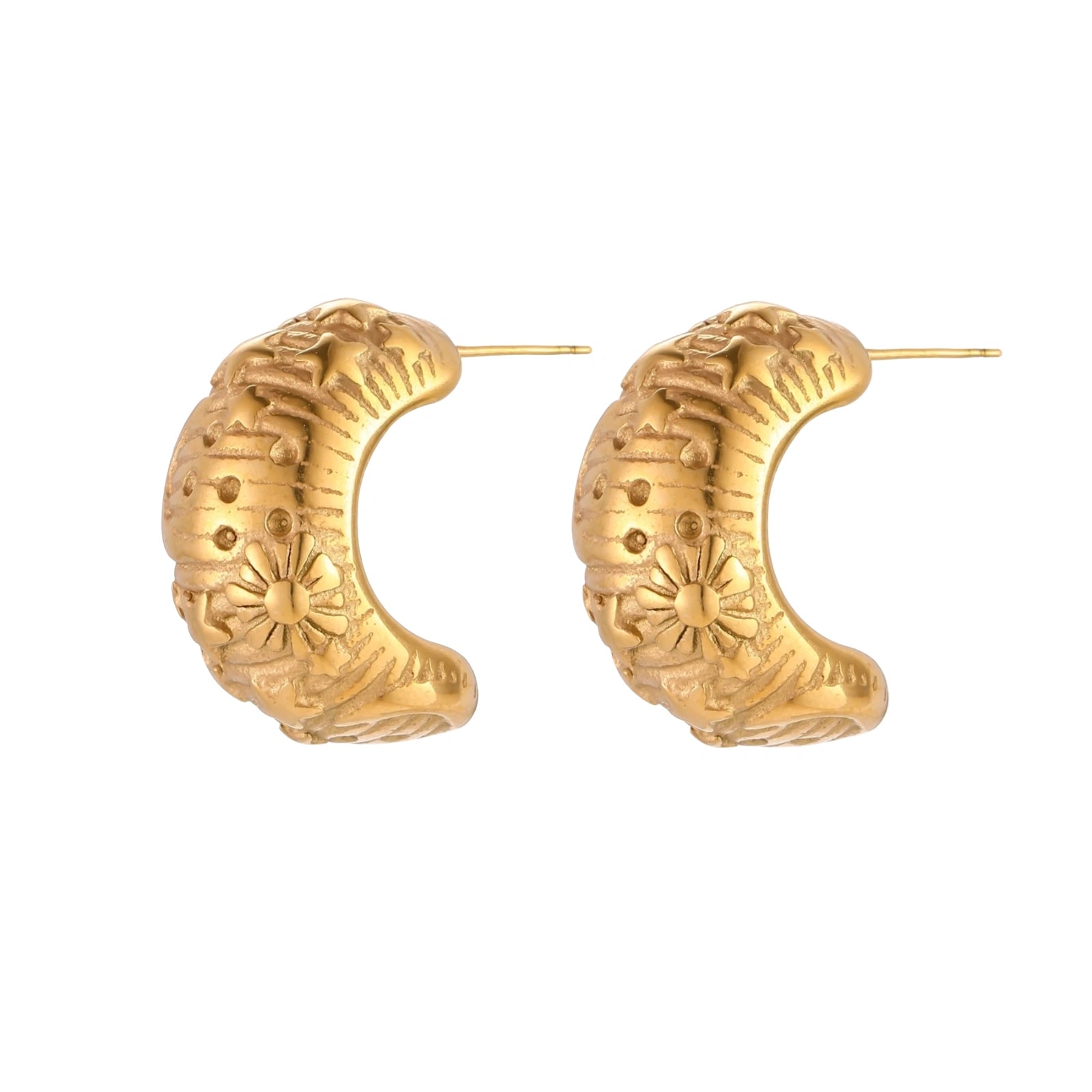 Wide gold hoop earrings with embossed stars and sun motifs on cream background, showing dimensional relief details.