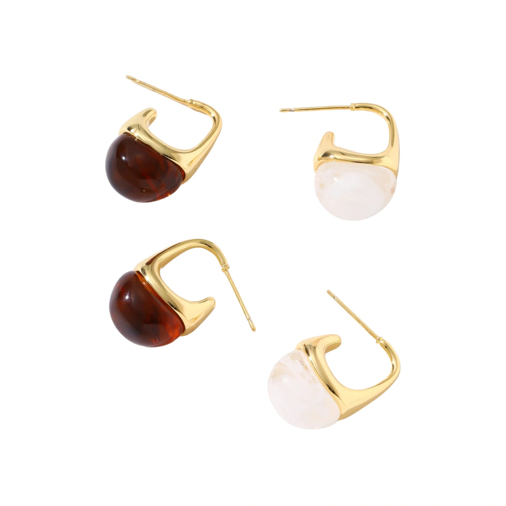 Modern drop earrings with curved gold-plated copper tops and amber resin bottoms creating an organic teardrop silhouette.