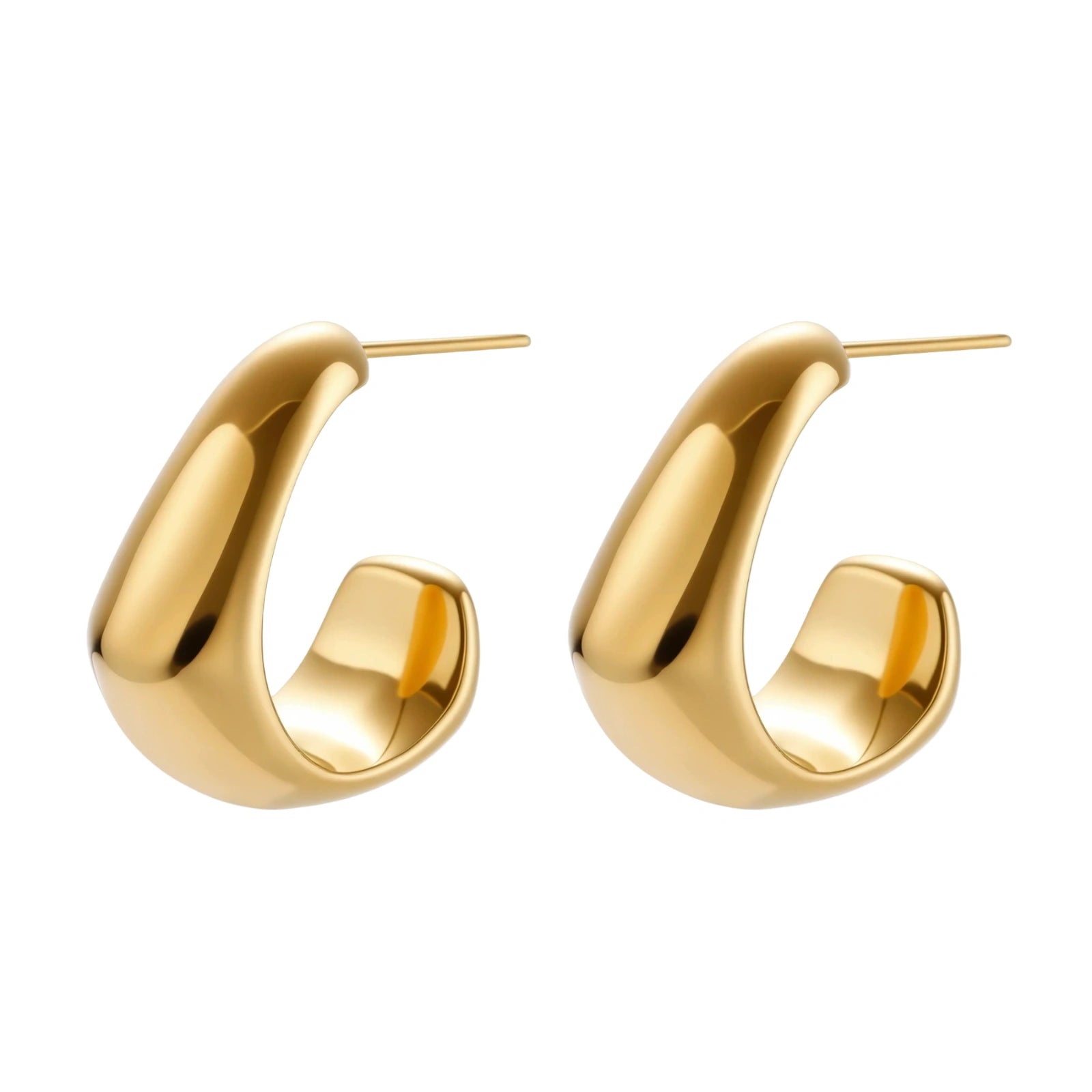 Close-up of curved gold-plated huggie earrings with sculptural design on white background, showing polished finish.