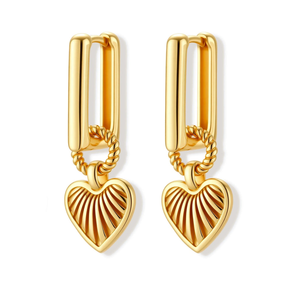 Gold-plated huggie earrings with textured heart charms featuring radiating sunburst patterns on white background.